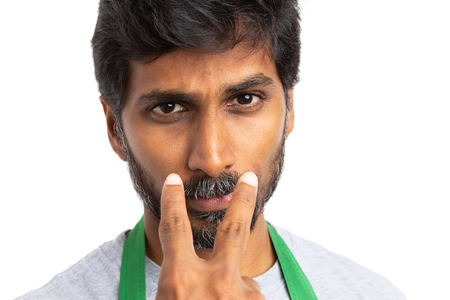 Store owner or hypermarket employee pointing at camera making look at me gesture as supervise...