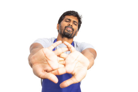 Supermarket or hypermarket indian male employee stretching knuckles as getting ready concept...