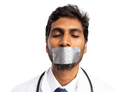 Indian medic silenced with mouth being taped as do not tell professional secret isolated on whiteの写真素材