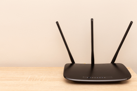 Black router on top of furniture as home internet or wi-fi conceptの写真素材