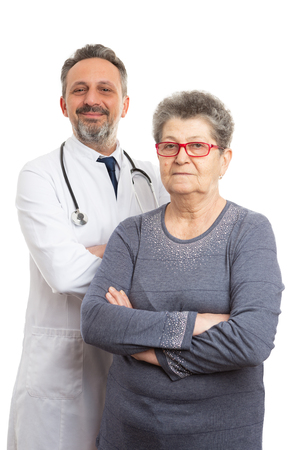 Portrait of smiling male doctor and serious female patient with crossed arms posture isolated on white backgroundの写真素材