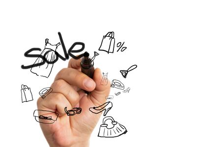 Man writing sale text on transparent screen with clothing doodles by using black marker isolated on white backgroudの写真素材
