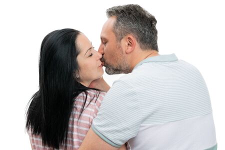 Closeup of man and woman couple kissing as romantic couple concept isolated on white studio...
