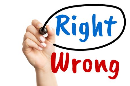 Closeup of woman circling red right word on transparent screen with red wrong text isolated on white backgroundの写真素材