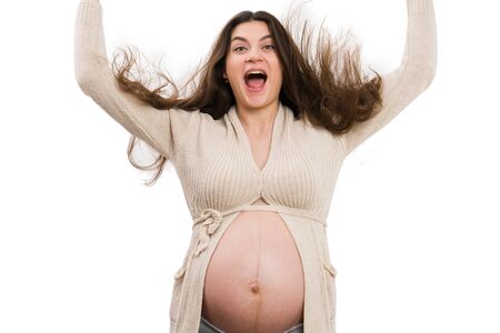 Pregnant woman letting hair down isolated on white background as silly conceptの写真素材