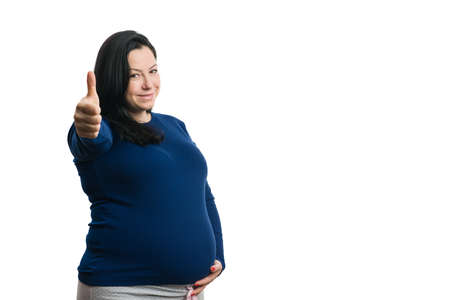 Smiling pregnant woman holding string with ultrasound pictures and red heart as love concept...
