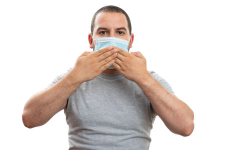 Adult man covering mouth with hands while wearing disposable medical or surgical covid19 sars flu...