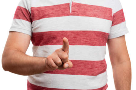 Close-up of adult man touching invisible or transparent blank copyspace as screen with index finger wearing summer attire isolated on white studio backgroundの写真素材