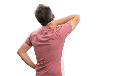 Adult male model in summer attire having muscle pain strained touching neck with back to camera...