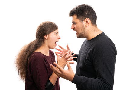Male and female couple wearing casual autumn attire arguing shouting with angry mad expression and gesture isolated on white studio backgroundの写真素材