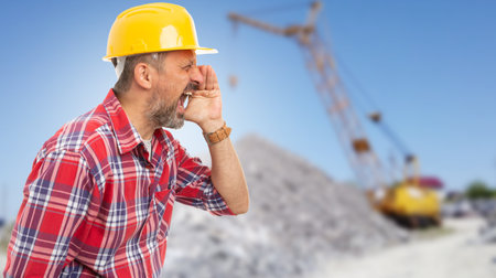 Close-up of worker making sound amplification gesture with hands as loud workplace conceptの写真素材