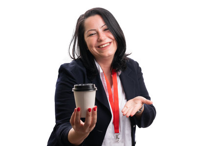 Smelling businesswoman wearing smart casual suit presetning paper take-away cup of hot coffee as office work corporate morning isolated on whiteの写真素材