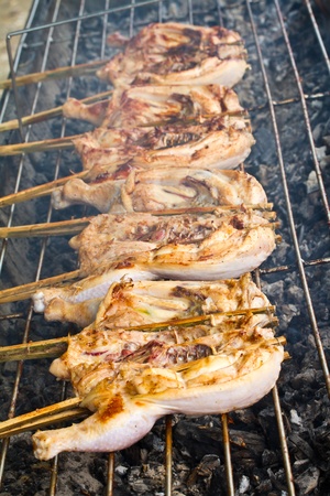 Grilling chickens on fireの写真素材