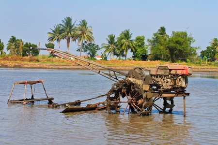 Tilling tractor in the rice fieldの写真素材