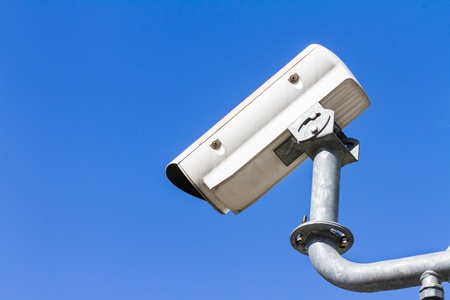 CCTV against blue sky, security cameraの写真素材