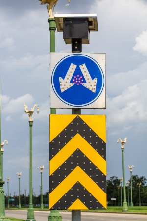 Road split sign with led light and solar cell on topの写真素材