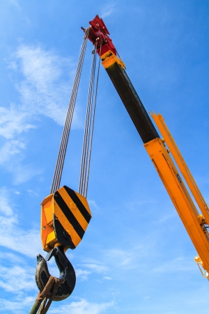 Hydraulic crane beams against blue skyの写真素材