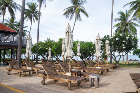 Wooden chairs on pool deckのeditorial素材