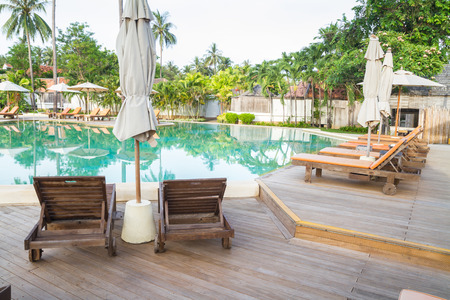 Wooden chairs on pool deckのeditorial素材