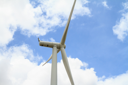 Wind turbine against blue sky