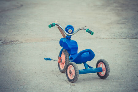 Old childhood tricycle in vintage styleの写真素材