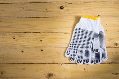 Gloves on wooden background in vintageの写真素材