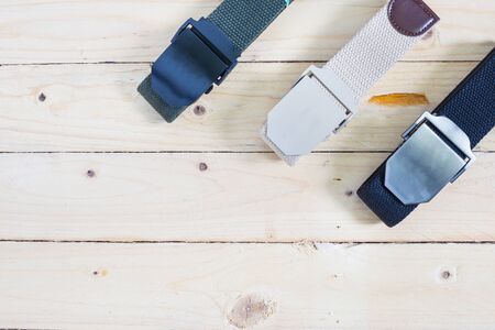 Men's fashion outdoor military tactical belt on wooden tableの写真素材