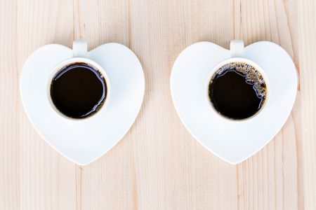 Two white coffee cup on wooden table in top viewの写真素材