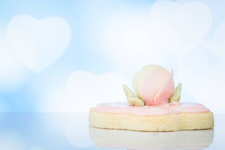 Biscuit top with sugar rose flower on blurry bokeh background
