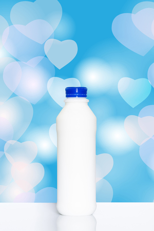 Bottle of milk on colorful heart shaped bokeh background., clipping path includedの写真素材