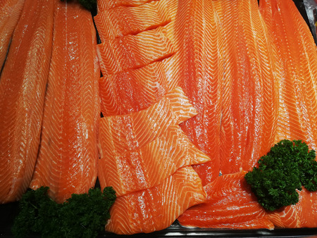 Salmon fillets frozen on ice for sale in supermarketの写真素材