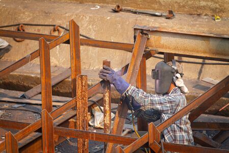 Industrial welder welding fabricated construction in factory