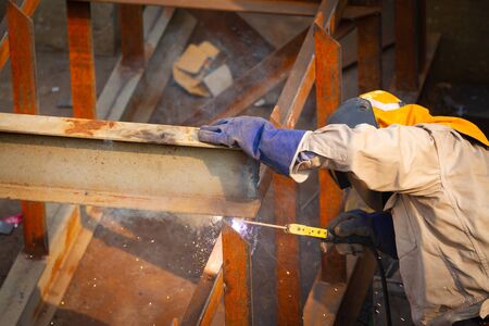 Industrial welder welding fabricated construction in factoryの写真素材