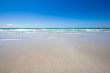 Beautiful beach with sandy and blue sky backgroundの写真素材