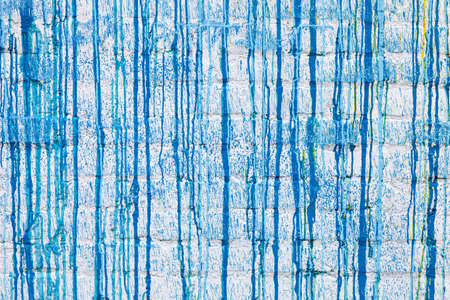 Blue paint drips on a white wall abstract grunge color background textureの写真素材