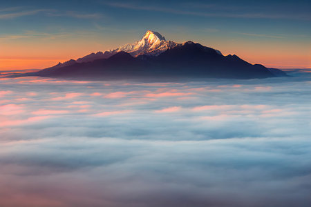 Mountain peaks in the fog at dawn. Foggy mountains