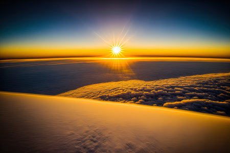 View from above shows a brilliant yellow dawn over white, thick clouds and a blue skyの素材