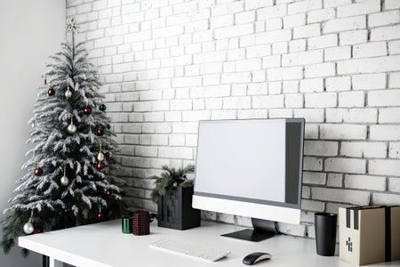 White brick wall beside office with computer Christmas tree and giftsの素材