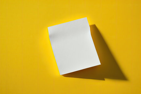One blank white piece of paper against a bright yellow backdrop. Generative AIの素材