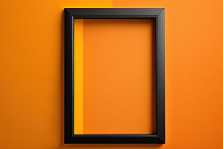 Hanging on an orange wall is a black photo frame. Template for a blank mockupの素材