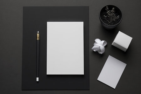 Black plate and stationery card in a minimalist flat lay. mockup in top perspective. advertising space or a greeting card. superior photographの素材