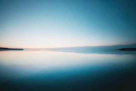 Minimalistic minimalist seascape in the horizon. Large panoramic aerial image of the sunset with a calm blue water and a beautiful skyの素材