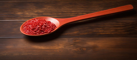 Wooden spoon with red rice on table, kitchen utensil with food ingredientの素材