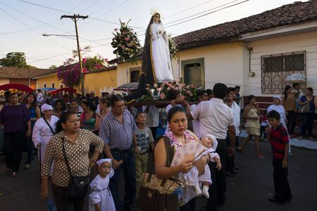 Leon, Nicaragua - April 14, 2014: People in a procession in the streets of the city of Leon in Nicaragua during the Easter celebrationsのeditorial素材