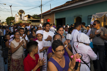 Leon, Nicaragua - April 14, 2014: People in a procession in the streets of the city of Leon in Nicaragua during the Easter celebrationsのeditorial素材