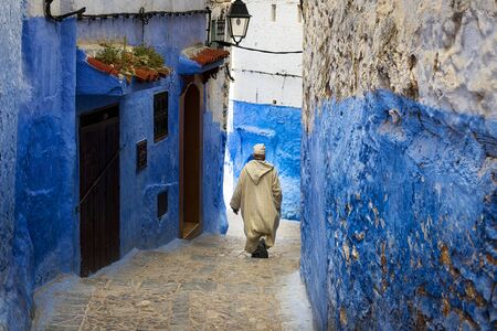Chefchaouen, Morocco - April 10, 2016: A man walking in a street of the town of Chefchaouen in Morocco.のeditorial素材