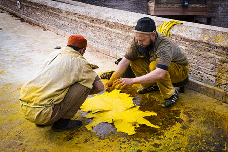 Fez, Morocco - April 11, 2016: Two man working in a tannery in the city of Fez in Morocco.のeditorial素材
