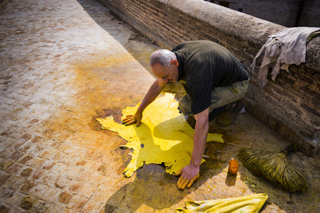 Fez, Morocco - April 11, 2016: One man working in a tannery in the city of Fez in Morocco.のeditorial素材