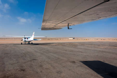 Two light aeroplanes parked in the runway in Namibiaの写真素材