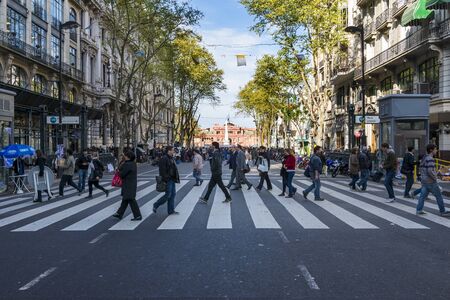 Buenos Aires, Argentina - October 3, 2013: People crossing a pedestrian crossing in the Avenida de...